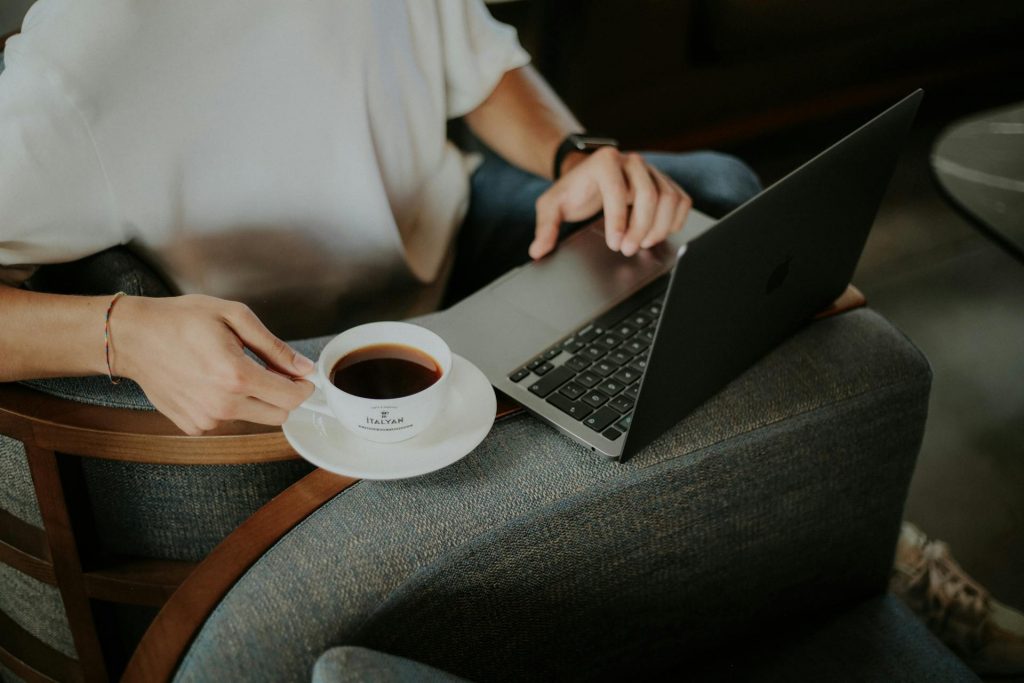 Person sitting with tea and laptop